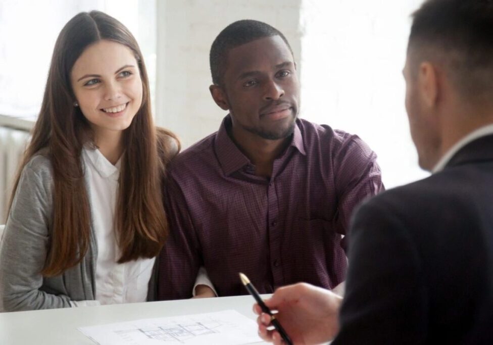 A man and two women are sitting at a table